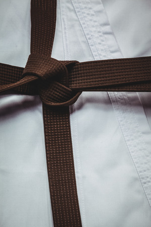 Close-up of karate uniform and brown beltの写真素材