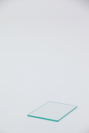 Close-up of glass sheet against grey backgroundの写真素材