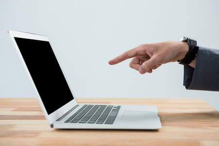 Hand of businessman pointing at laptopの写真素材
