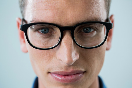 Portrait of man in spectacles against white backgroundの写真素材
