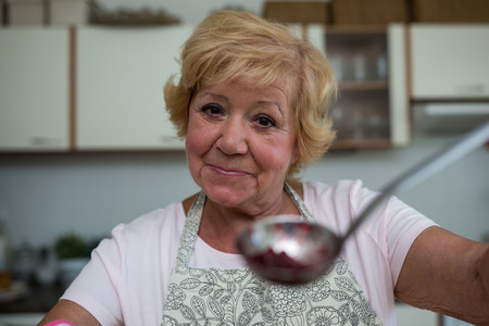 Portrait of senior woman preparing jam in kitchenの写真素材