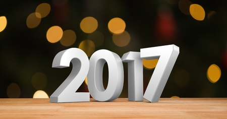 2017 on wooden plank against a composite image 3D of bright bokeh lights