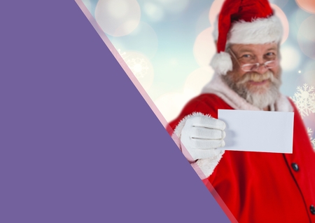 Santa claus holding a white card against christmas backgroundの写真素材