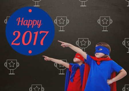 Composite image of children in super hero costumes pointing at new year greeting quotesの写真素材