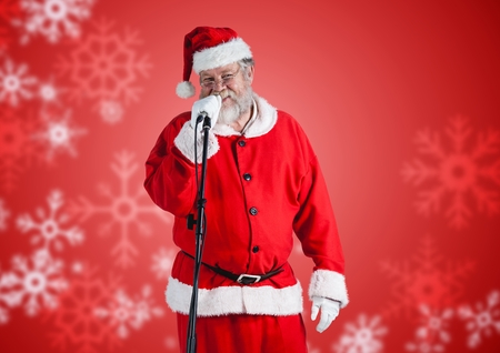 Portrait of santa claus singing on microphoneの写真素材