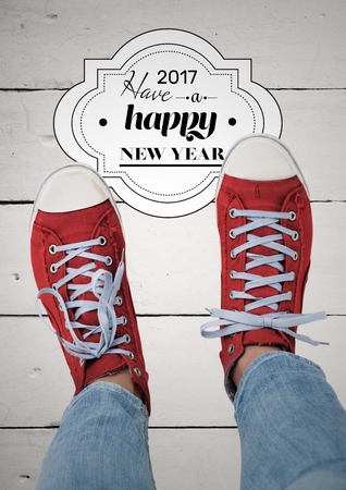 2017 new year wishes with teenager wearing red sneakers against wooden backgroundの写真素材