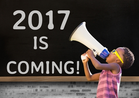 Boy with megaphone against 2017 new year sign on blackboardの写真素材