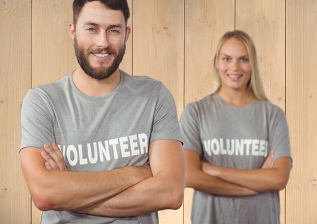 Portrait of volunteer couple standing with arms crossedの写真素材