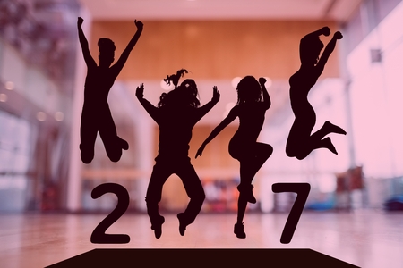 Silhouette of jumping people forming 2017 new year sign against dance studio in background