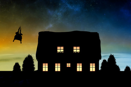 Rear view of Santa Claus riding on sled against digitally generated snowy land scapeの写真素材