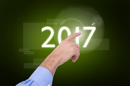 Hand of a businessman pointing something against green background with vignette