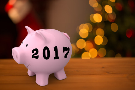 Digital image of new year 2017 against desk with christmas tree in background