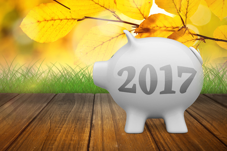 Digital image of new year 2017 against yellow leaves over wooden planks