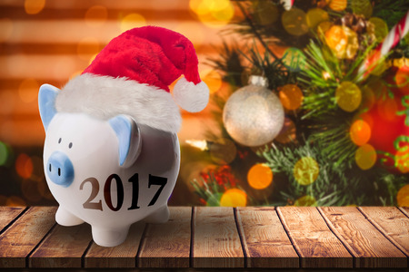 Digital image of new year 2017 against composite image of wooden table