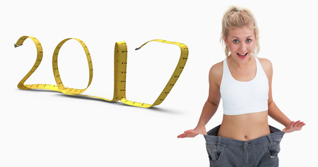 3D Thin woman wearing old pants after losing weight against 2017 made of measuring tape