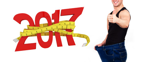 3D Digitally generated image of new year with tape measure against portrait of man happy after...