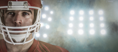 3D American football player looking at camera against splashing of yellow color powderの写真素材