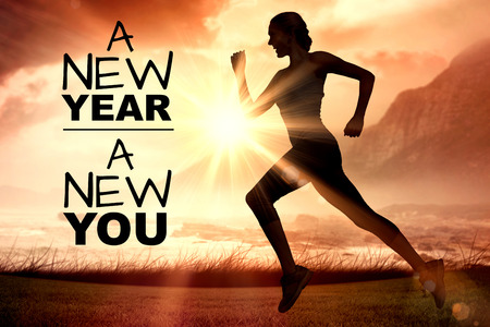 New year new you against side view of silhouette woman runningの写真素材