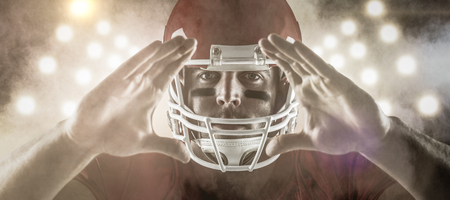 3D American football player making hand gesture against splashing of color powder