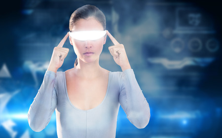 3D Woman using virtual video glasses against glowing technological backgroundの写真素材