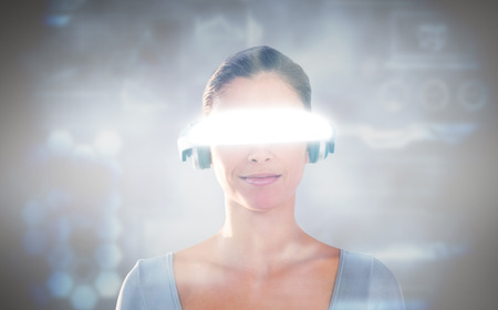 3D Beautiful young woman using virtual video glasses against grey vignette