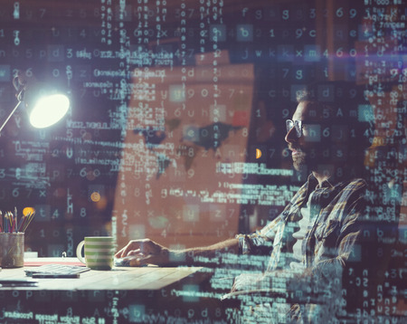 3D Businessman using computer at night in office