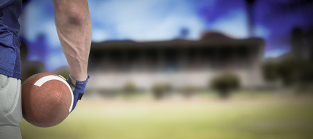 3D Midsection of sport person holding ball against gloomy skyの写真素材
