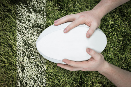 3D A rugby player scoring a try against grass backgroundの写真素材