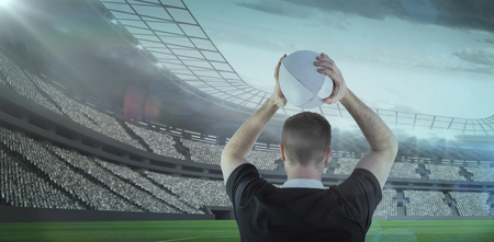 3D Rugby player about to throw a rugby ball against rugby stadiumの写真素材