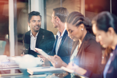 Businesswoman interacting with colleagues in office