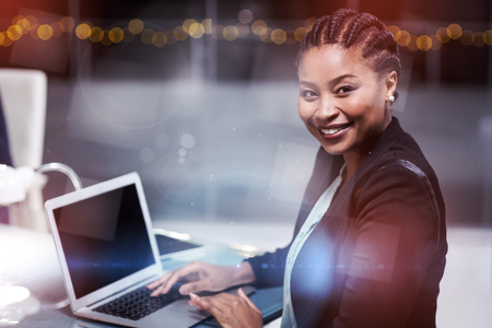 Portrait of businesswoman using laptop in officeの写真素材