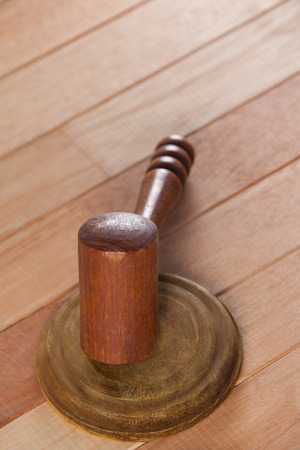 Close-up of wooden gavel placed on wooden tableの写真素材