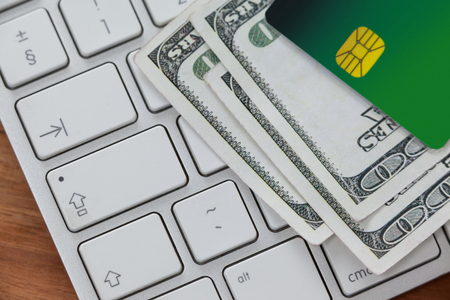 Close-up of smart card with currency notes on laptopの写真素材
