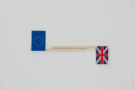 Close-up of small sticks with union jack and european union paper flag