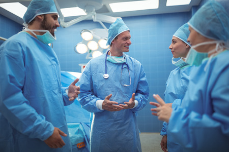 Team of surgeons having discussion in operation theater at hospitalの写真素材