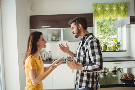 Couple having argument in kitchen at homeの写真素材
