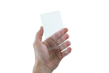 Hand using futuristic mobile phone against white backgroundの写真素材