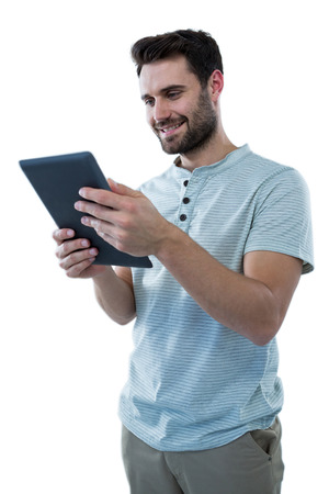 Smiling man holding a digital tablet against white backgroundの写真素材