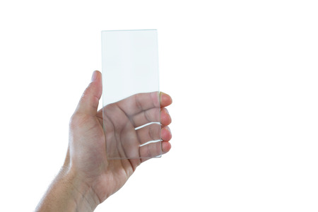 Hand holding futuristic mobile phone against white backgroundの写真素材