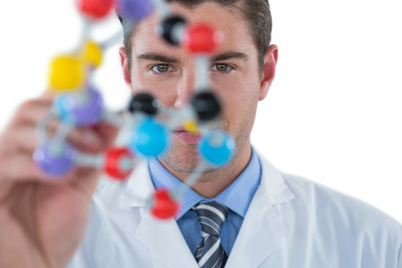 Scientist experimenting molecule structure against white backgroundの写真素材