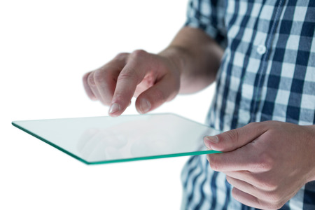 Mid section of man using futuristic digital tablet against white backgroundの写真素材