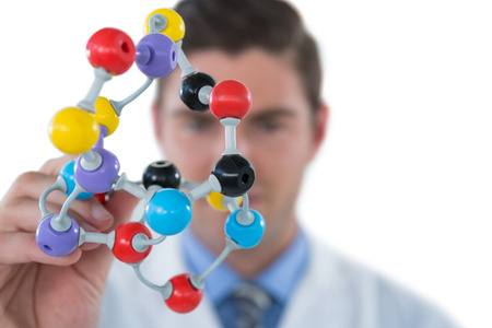 Scientist experimenting molecule structure against white backgroundの写真素材