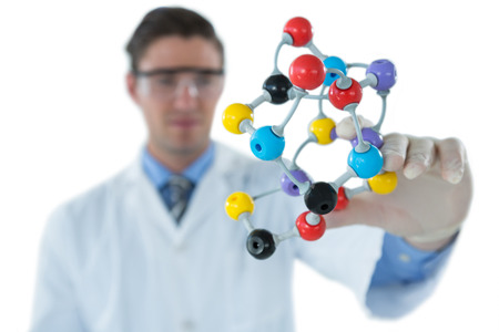 Scientist experimenting molecule structure against white backgroundの写真素材