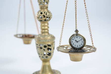 Close-up of pocket watch on weight scaleの写真素材