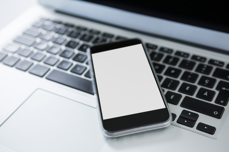 Close-up of laptop and smart phoneの写真素材