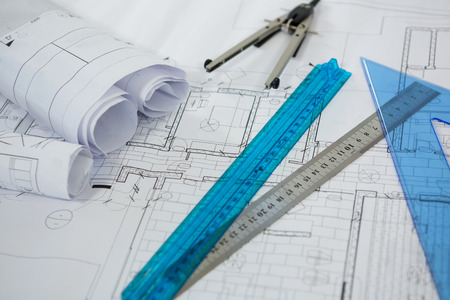Close-up of blueprint with ruler, pencil and thumbscrew compassesの写真素材
