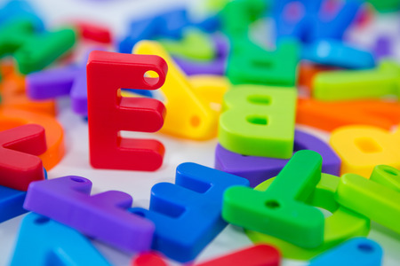 Close-up of E alphabet standing between toy alphabetの写真素材