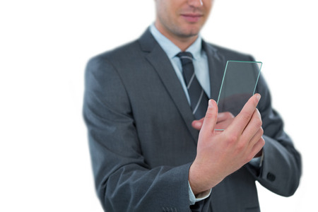 Businessman using futuristic mobile phone against white backgroundの写真素材