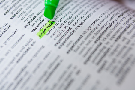 Close-up of marking a word experience with green markerの写真素材