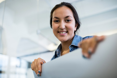 Portrait of smiling female graphic designers at desk in office